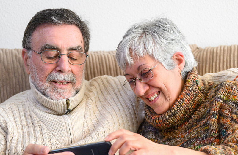 couple playing on their smartphone